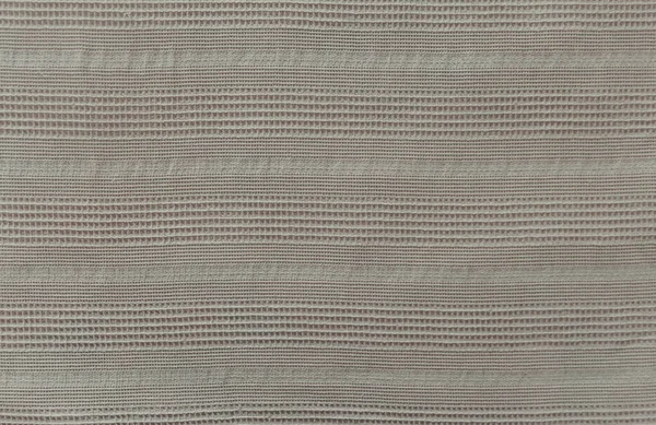 Cobertor de linho em uma cama com ornamento linear vertical. Textura de tecido bege. Fundo têxtil original. — Fotografia de Stock