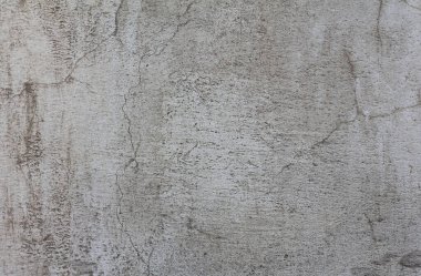 Boyanmış eskimiş beton duvar, gri soyut arka plan. Çizik ve çatlaklarla dolu beton bir duvar dokusu. Tasarımlarınıza kolayca derinlik ve organik doku ekleyin. Asgari şehir fotoğrafı.