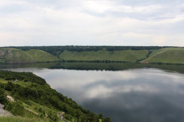 Bakota Bay view. The panoramic landscape of Dniester river, Ukraine. The banks of a large river with calm smooth water. Summer sunny day. High banks, green hills, panoramic river.
