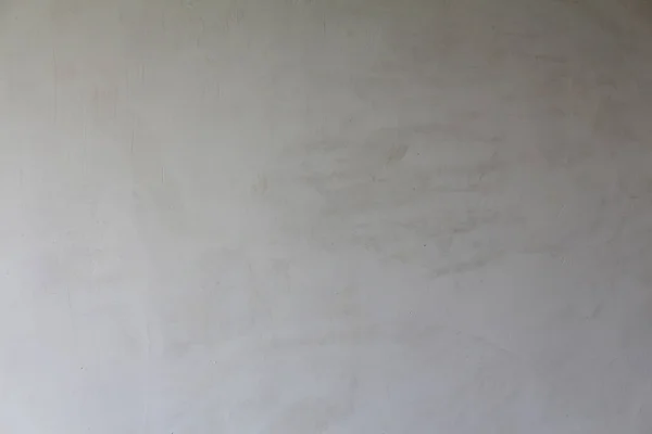 A drywall plastered surface with paint texture. Paint brushed damaged white wall background. Minimal urban photo. Easily add organic texture and depth to your designs.