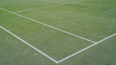 Sentetik tenis kortunun ayrıntıları. Yeşil üzerine beyaz çizgiler