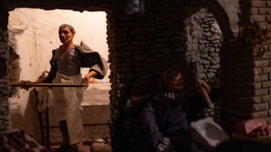detail of Nativity scene: baker with shovel in the oven.