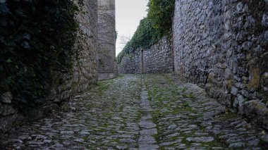 Alley in Erice, Sicily, Italy. Paved street and houses.