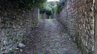 Alley in Erice, Sicily, Italy. Paved street and houses.