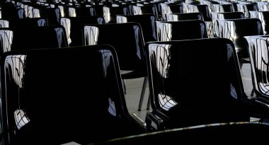 rows of empty black chairs in the great room
