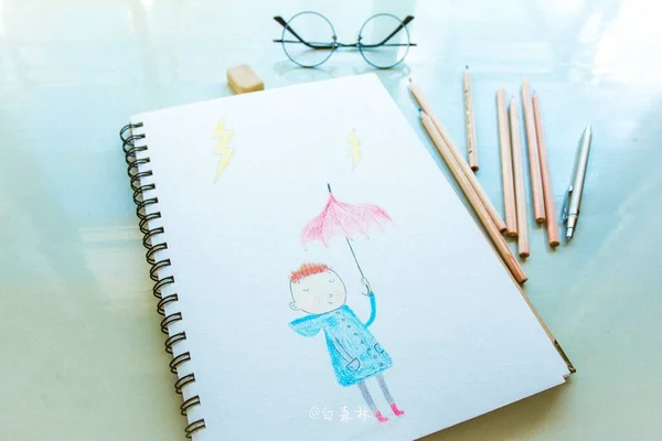 drawing of a pencil and a notebook on a white background