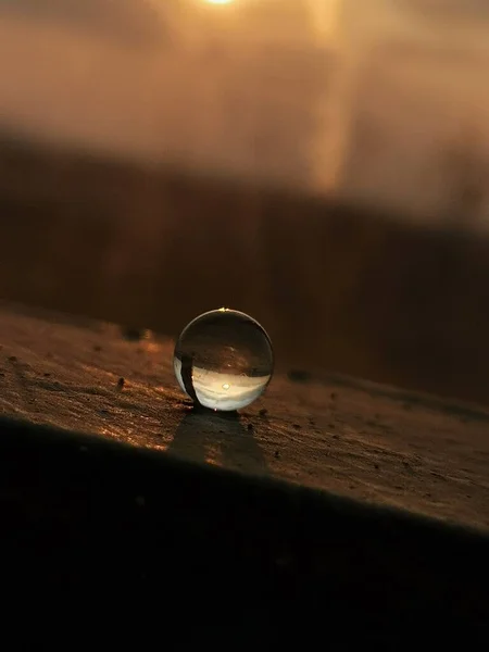 a glass of water drops on a wooden table