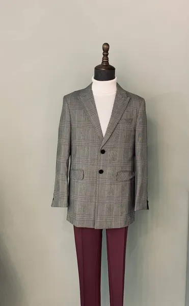 mannequin in a suit on a gray background