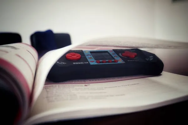 close up of a book with a pen and a stack of books