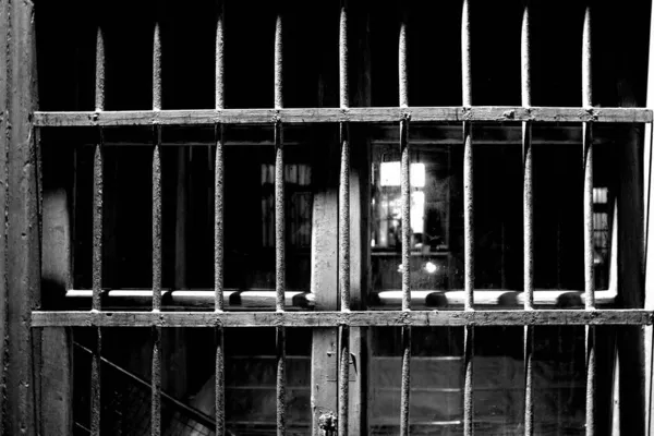 black and white photo of a prison cage