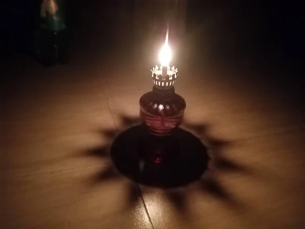 candle lamp on wooden table