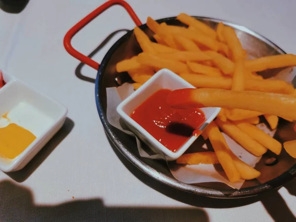 french fries and ketchup on a plate
