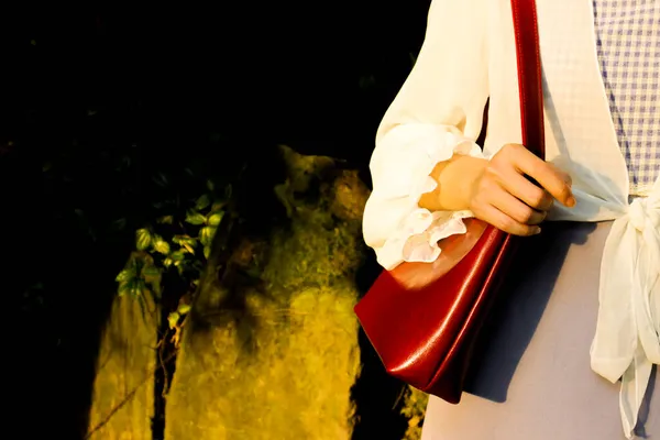 man with a bag of red roses in the hands of a woman