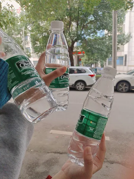 man pouring water from a bottle of beer