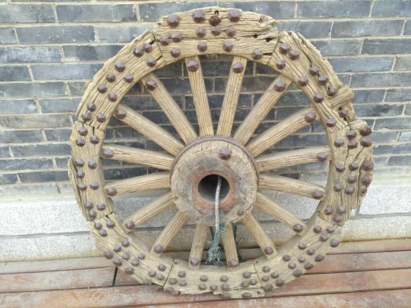 old wooden wheel on the roof of the house