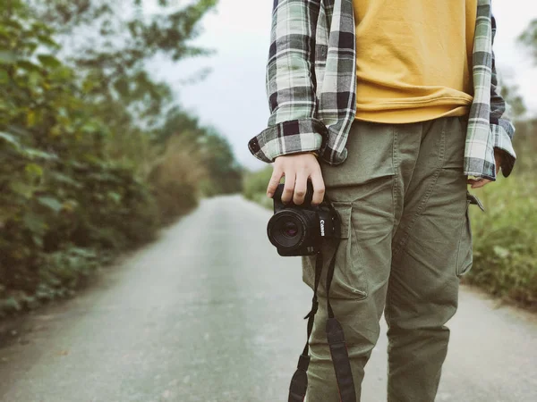 man with camera in forest, travel concept