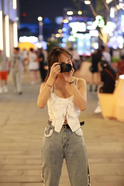 young woman with camera in the city