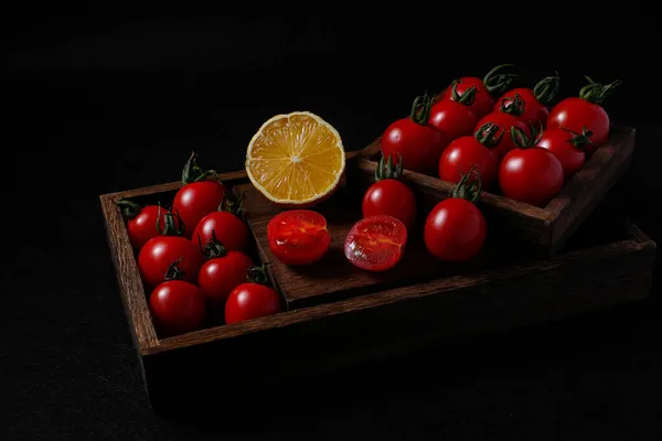 fresh tomatoes and tomato on black background