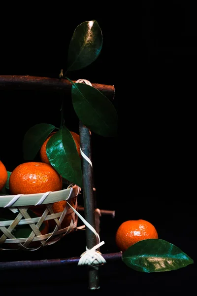 tangerines and oranges on a black background