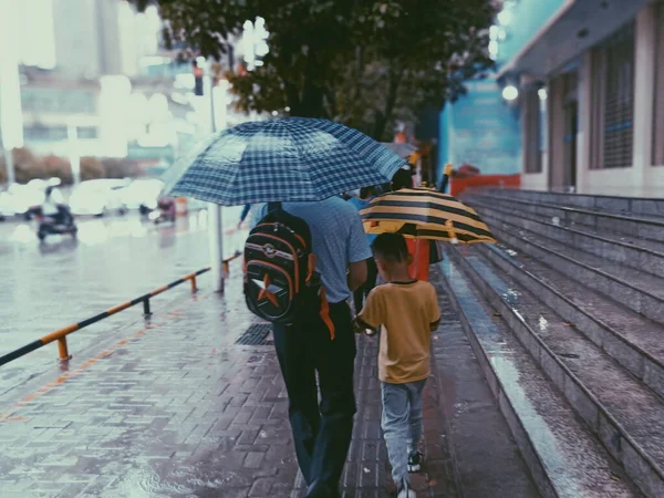 young woman with umbrella and umbrellas in the rain