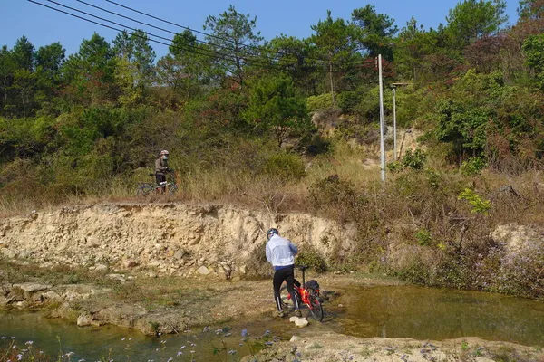 a man rides a bike in the mountains