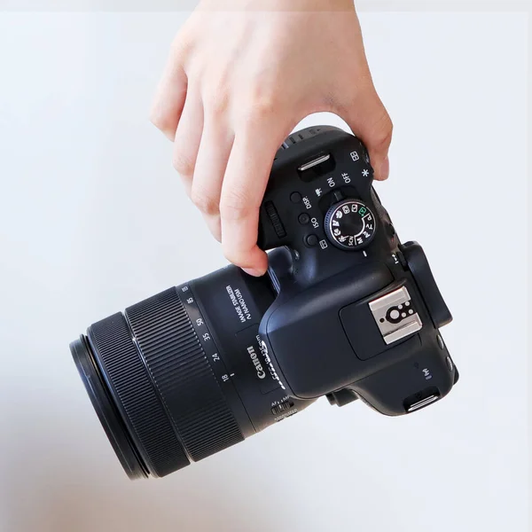 hand holding camera on a white background