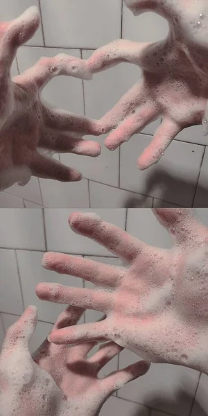 man washing hands with soap bubbles