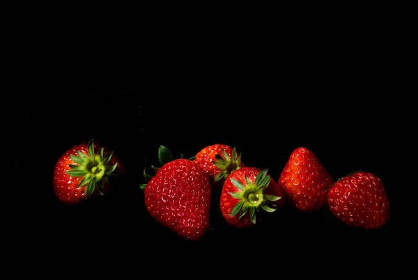fresh strawberries on black background