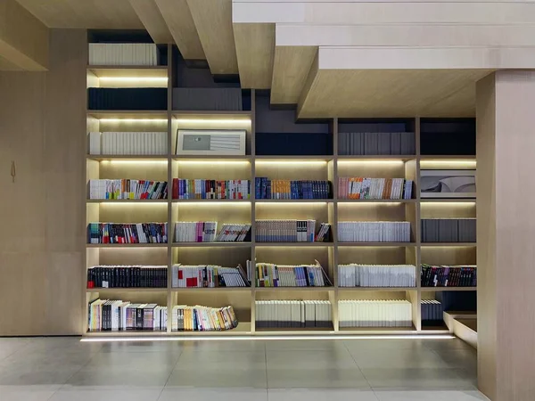 interior of a library room with books and a bookshelf