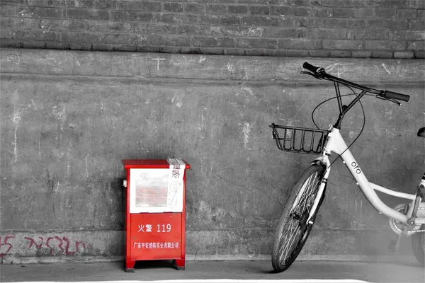 old and dirty street photo of a red and white bicycle