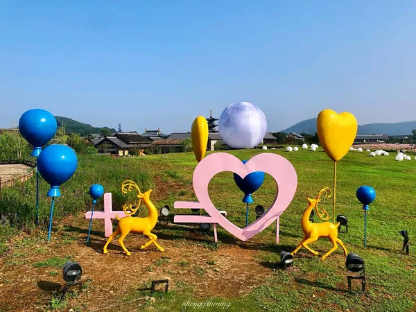 colorful balloons in the form of a heart on the beach