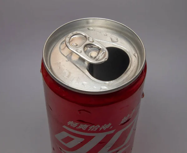 close up of a beer can with a lid and a straw cap