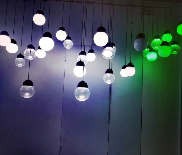 light bulbs hanging on a wooden background.