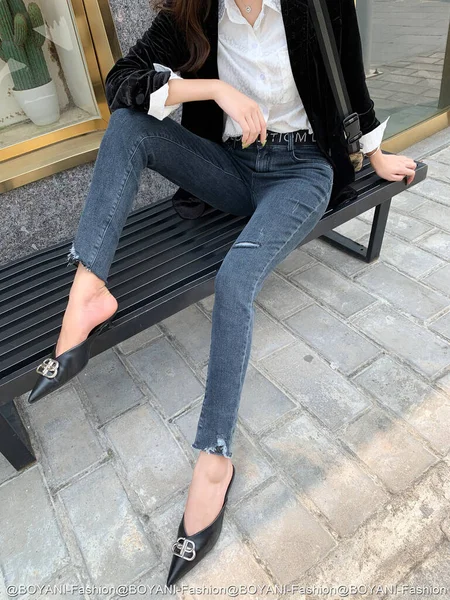 young woman in jeans and black boots