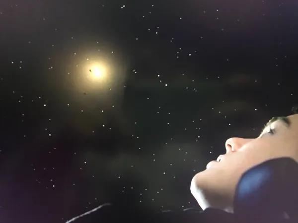 young woman with a black eyes in the night sky