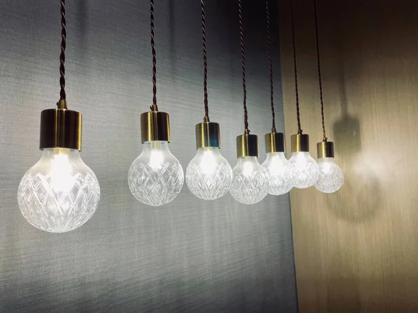 light bulb hanging on a rope on a dark background.