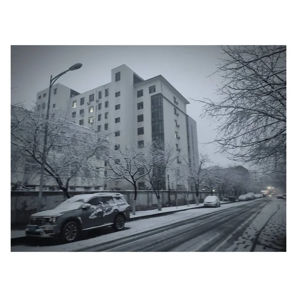 black and white photo of a city street with a road