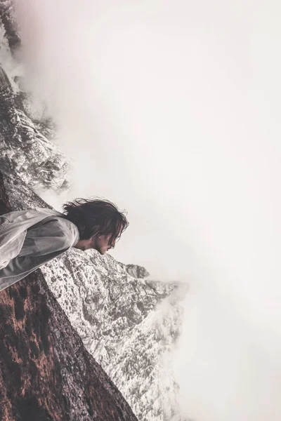 young woman with backpack and sunglasses in the mountains