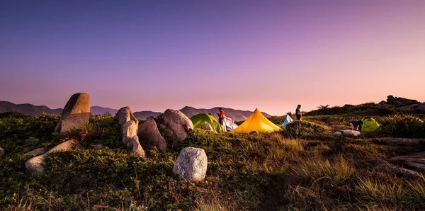beautiful landscape with a tent and a pyramid of stones