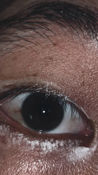 eye of a woman's face with a black eyes