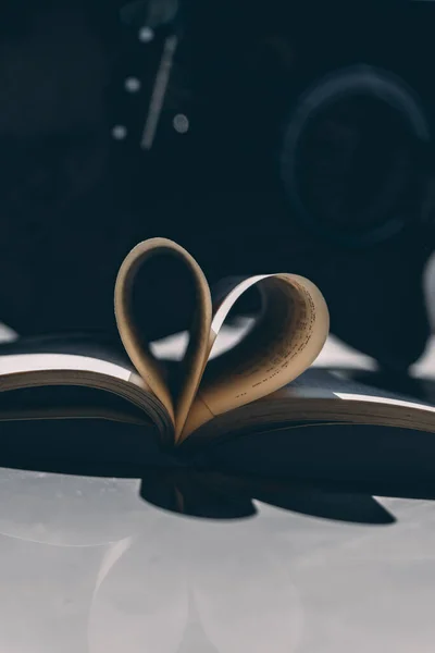 book and heart on a black background