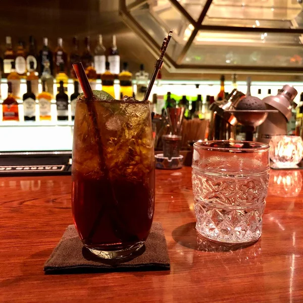 cocktail with ice and lemon on the bar counter