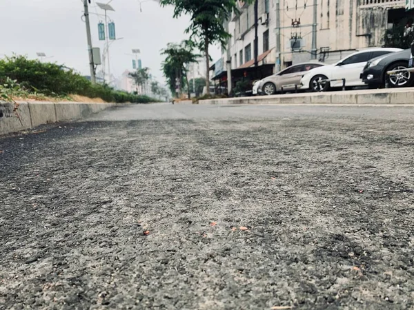 asphalt road with a car