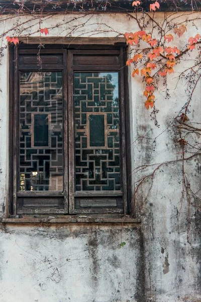 old wooden window with a red and white wall