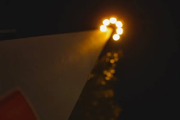 light bulb with lights on the background of the night sky