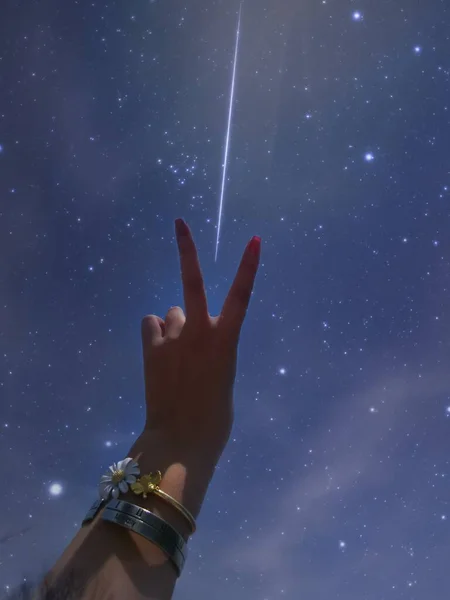 hand holding a star in the sky