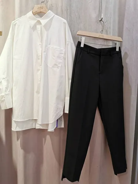 white shirt and black pants on a wooden background