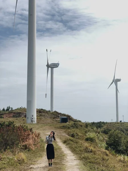 young woman with wind turbine