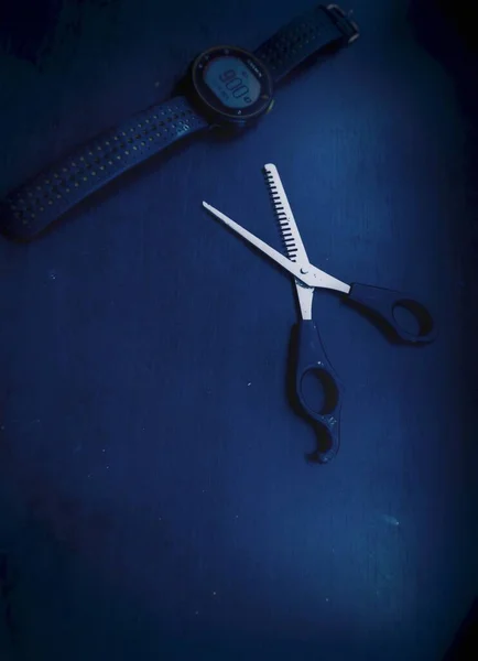 scissors and comb on a dark background