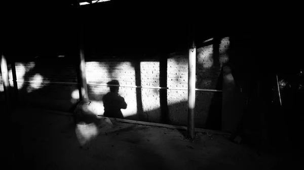 silhouette of a man in a black dress with a white background